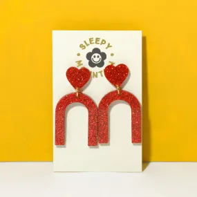 Heart arch dangle earrings in red glitter